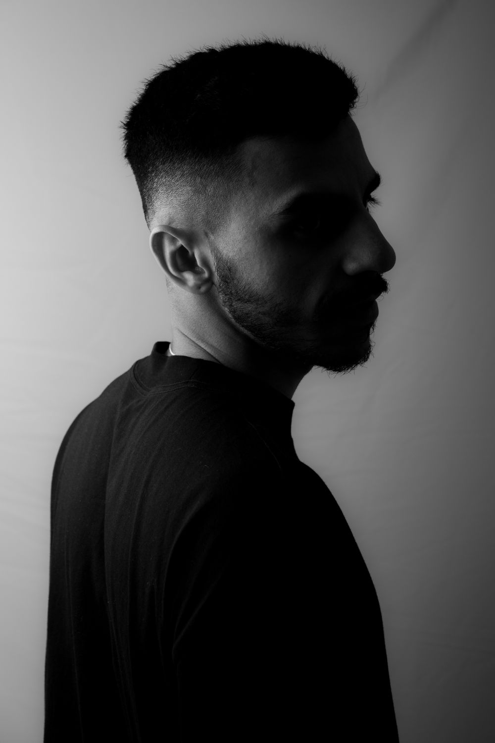 side profile of man with a short shadow taper fade and beard