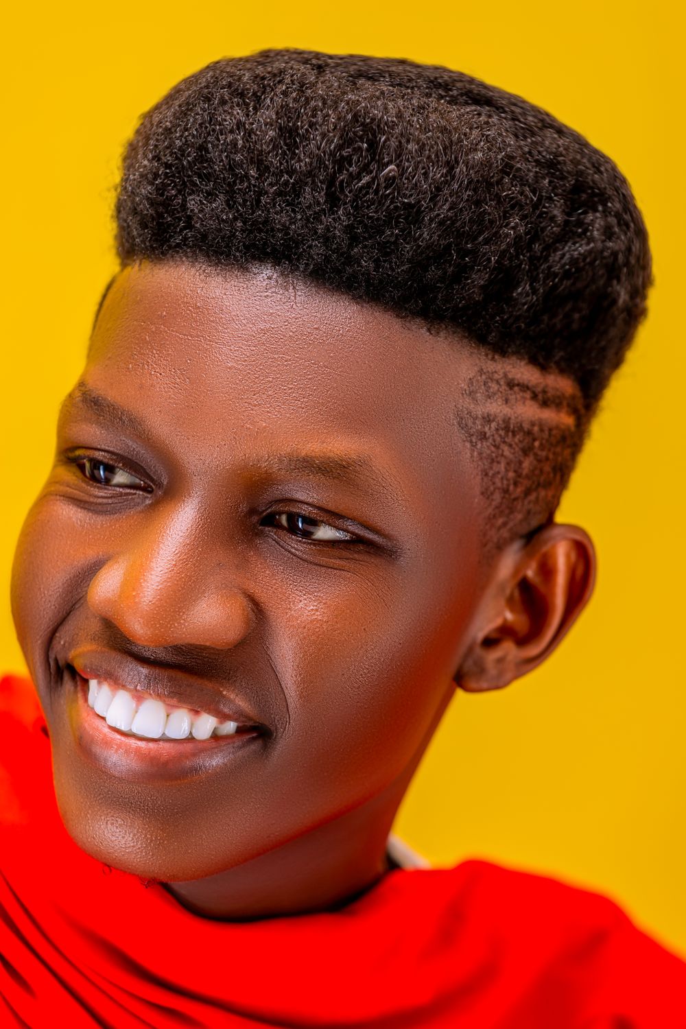 man with a shaped short afro and clean tapered sides