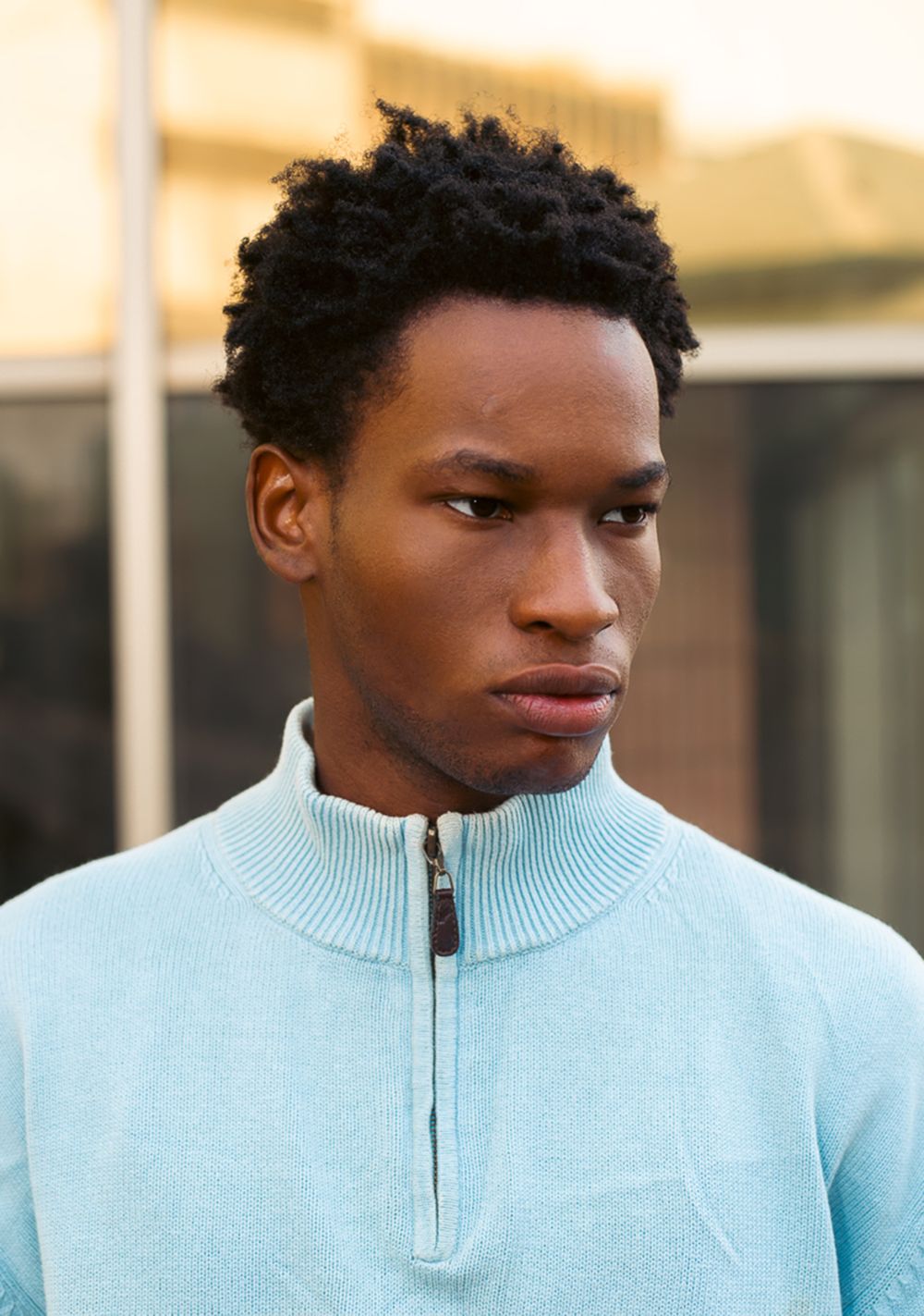 young man with a short natural afro and tapered sides