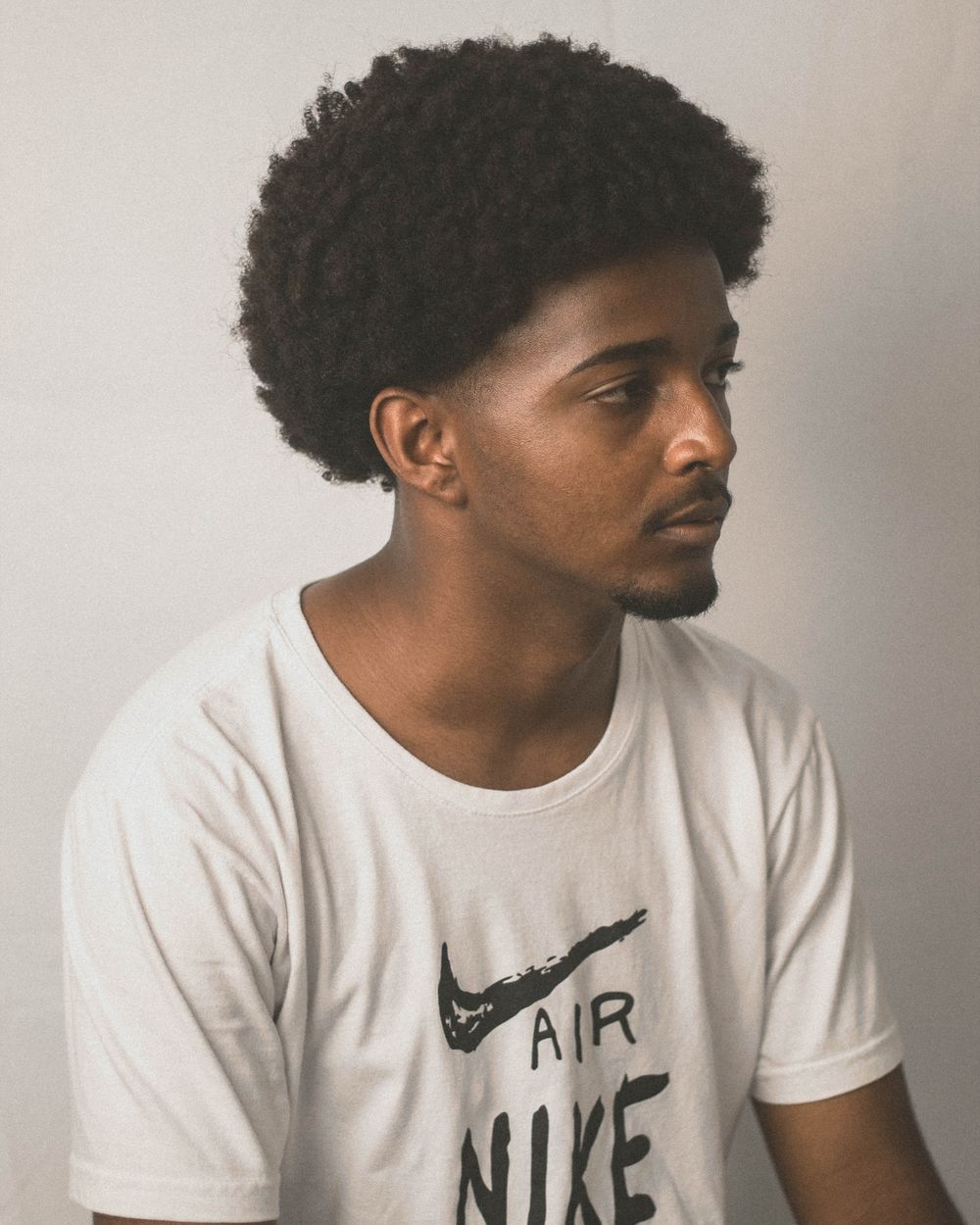 side profile of man with short shaped afro hairstyle