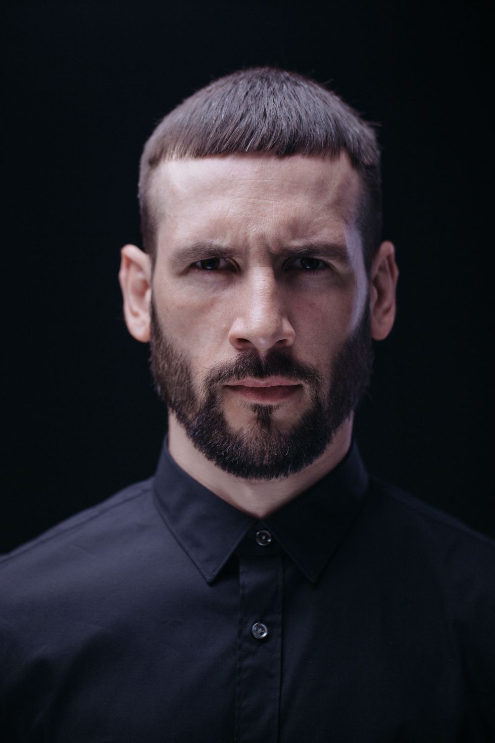 man with a short textured crop and close trimmed beard