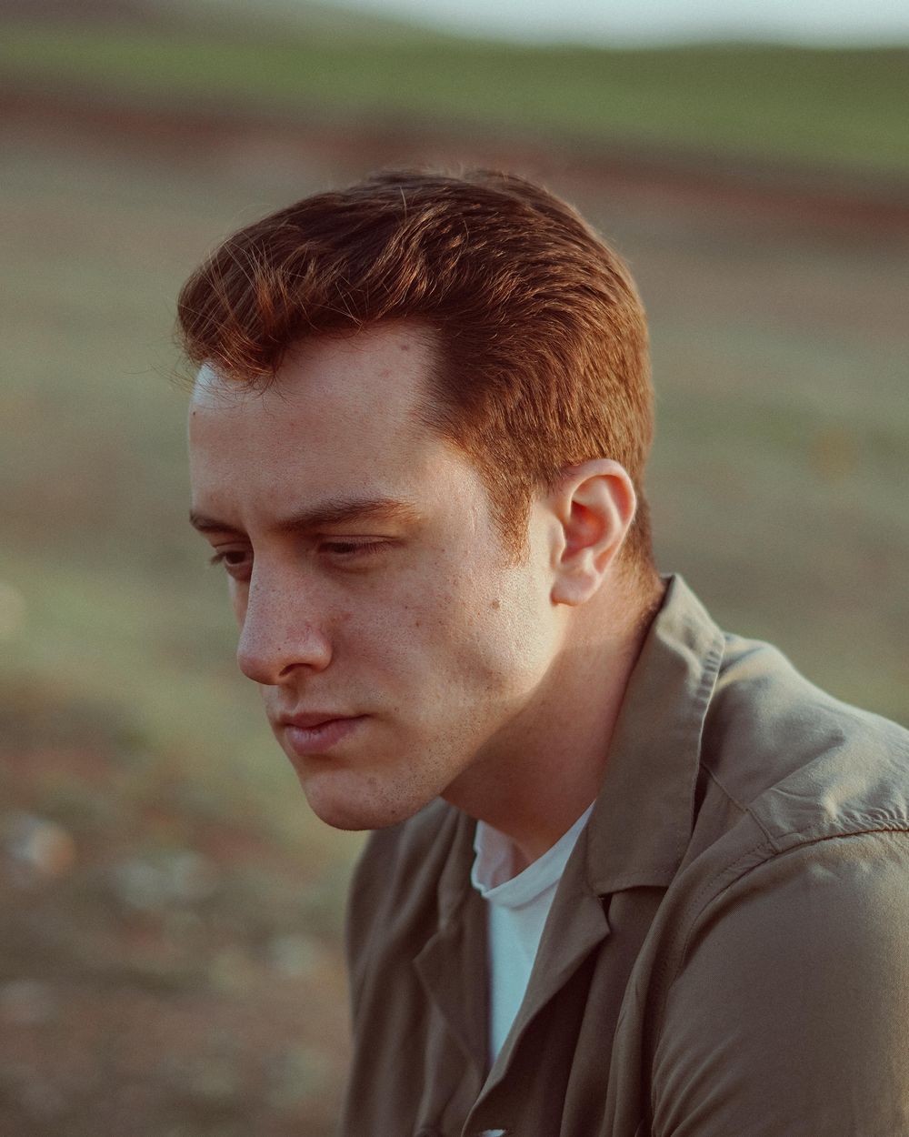 man with short textured haircut and receding hairline