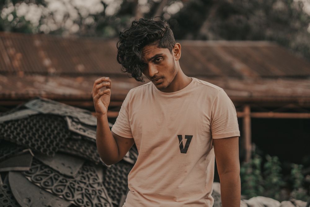 side profile of man with short wavy hair and tapered sides