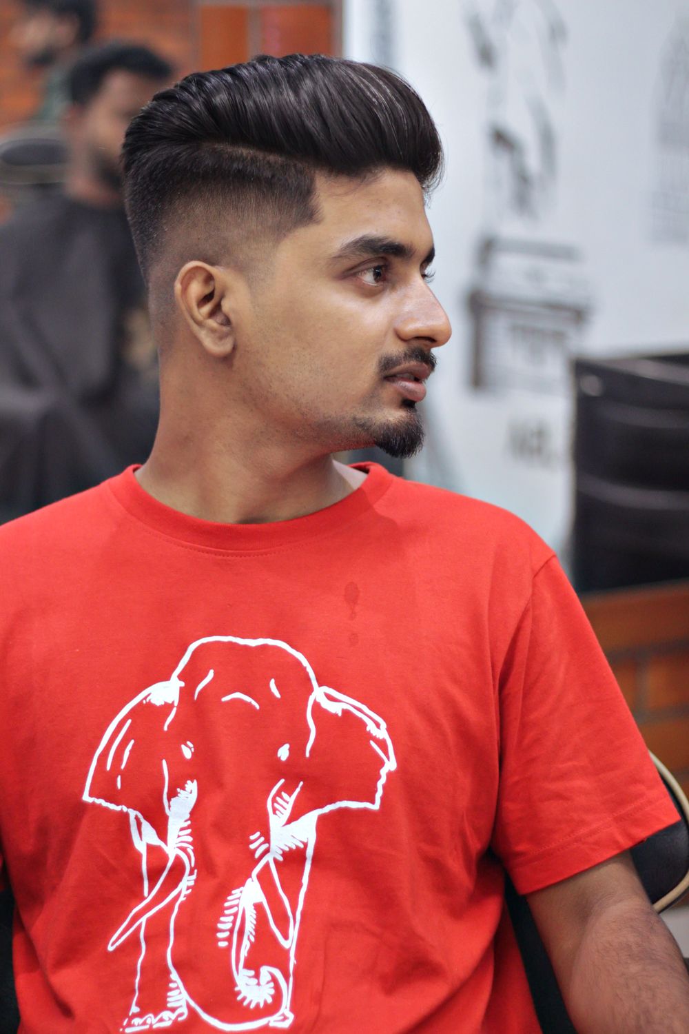 man with side part and low fade hairstyle
