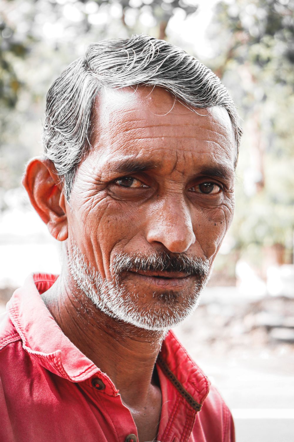 older man with silver short crop and mustache