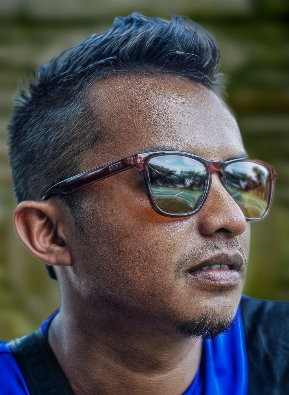 side profile of man wearing sunglasses with short silver tapered hair