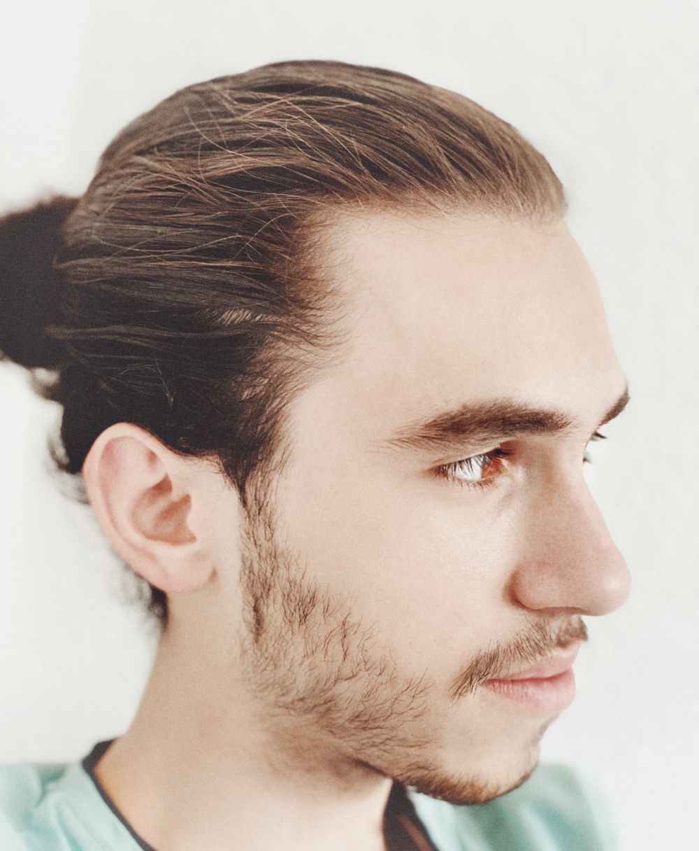 man with slicked back medium hairstyle and receding temples