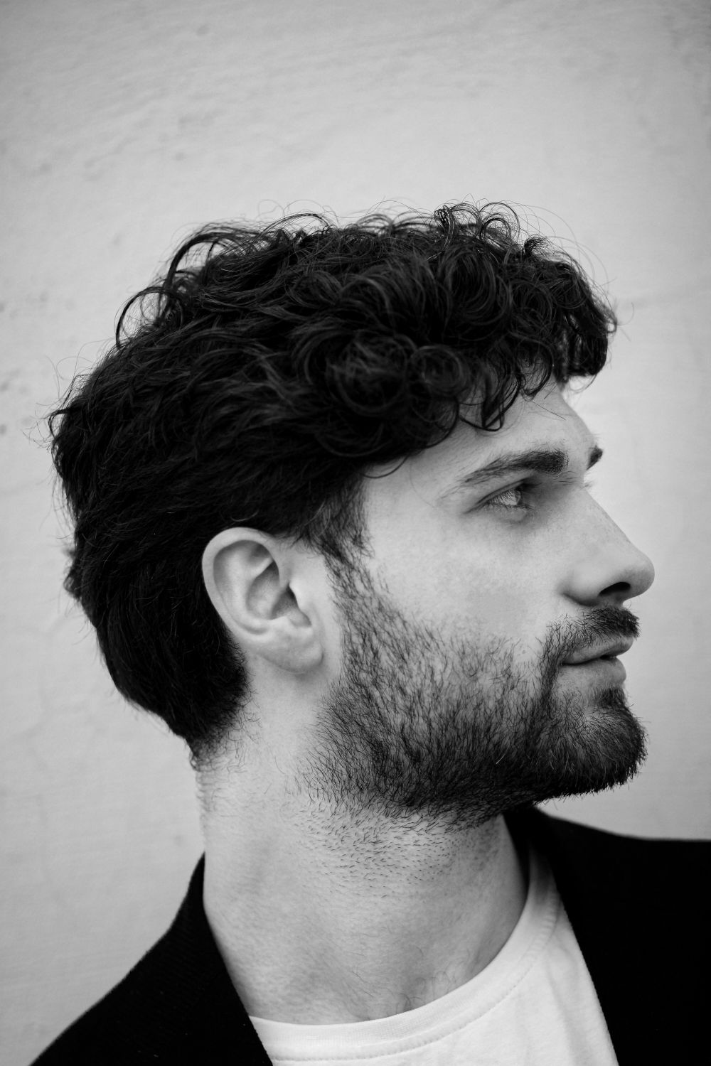 side profile of man with soft medium curls