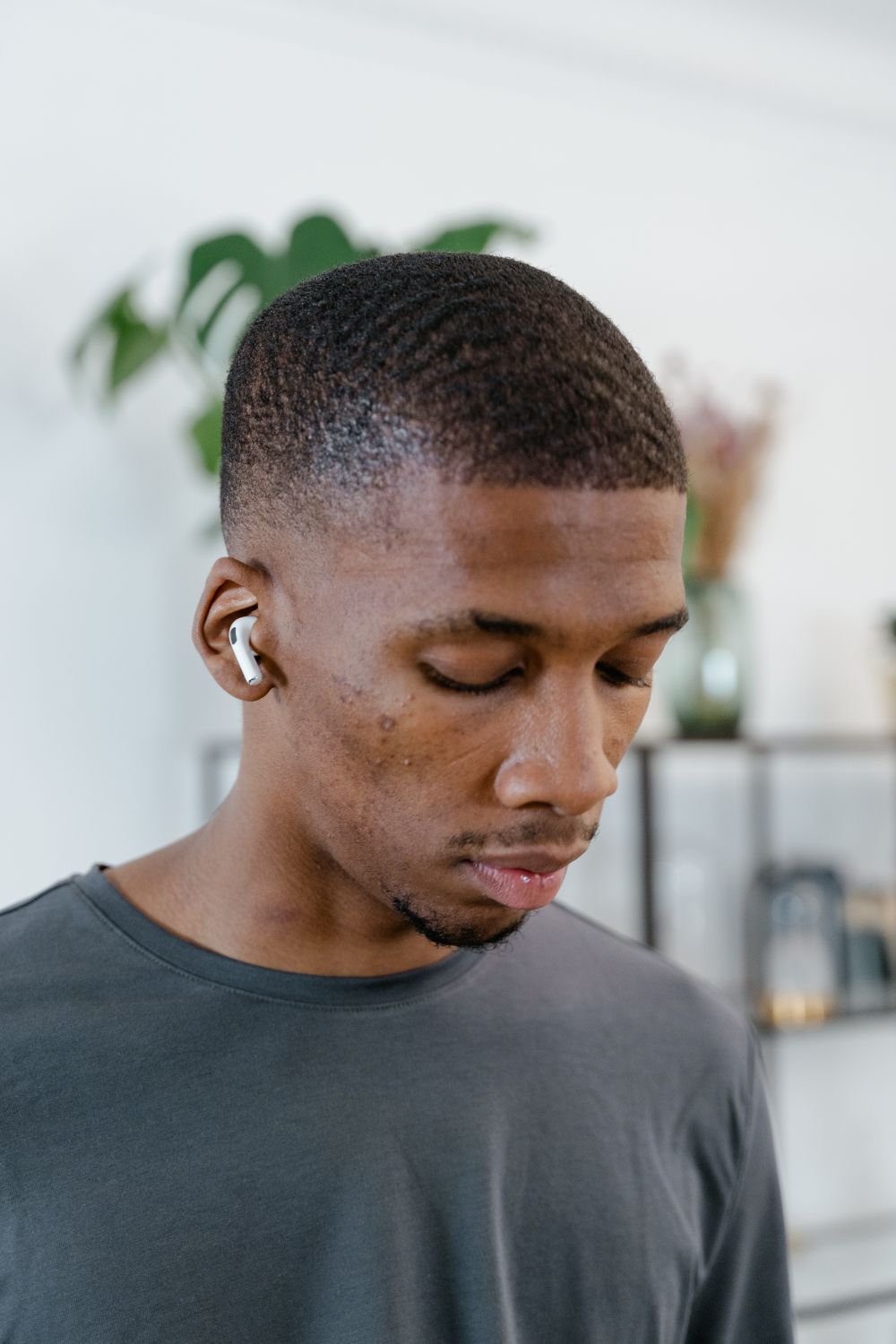 man with short natural waves and a low fade haircut