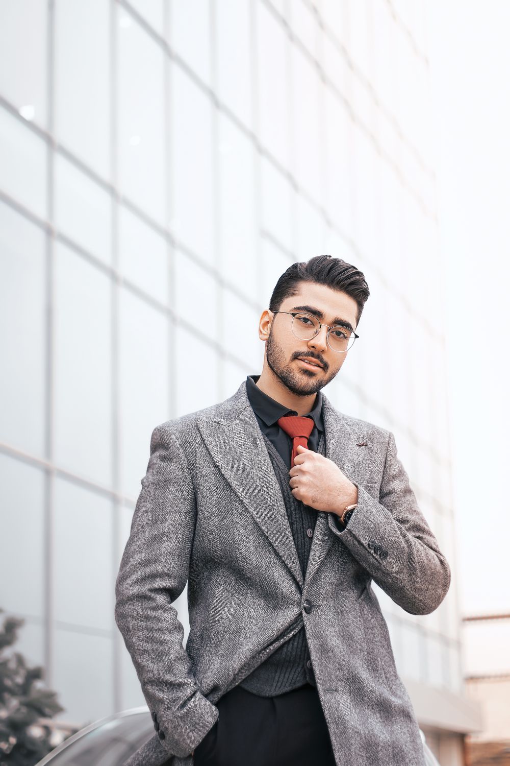 man in glasses and suit with polished side part hairstyle