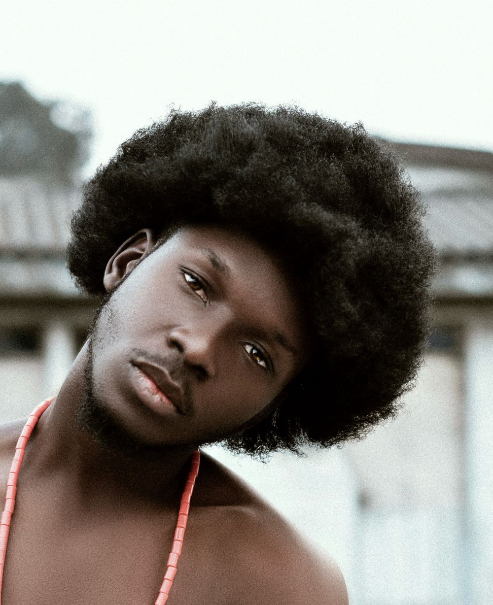 young man with tall afro hairstyle outdoors