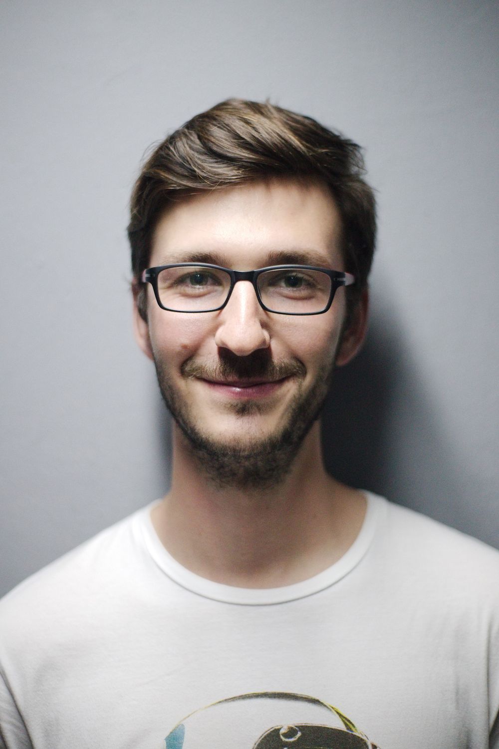man with textured short haircut and trimmed beard