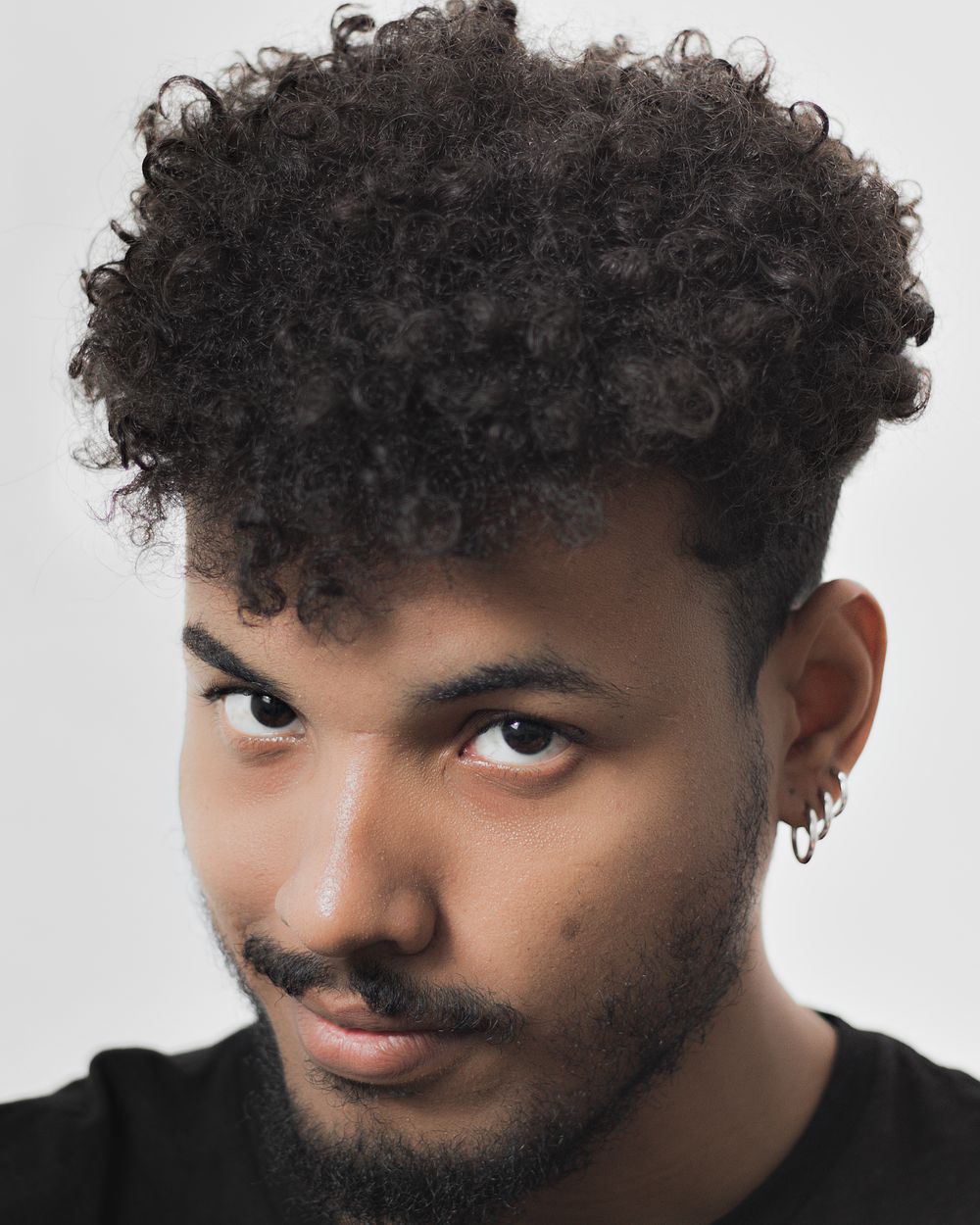 man with short textured curly crop hairstyle