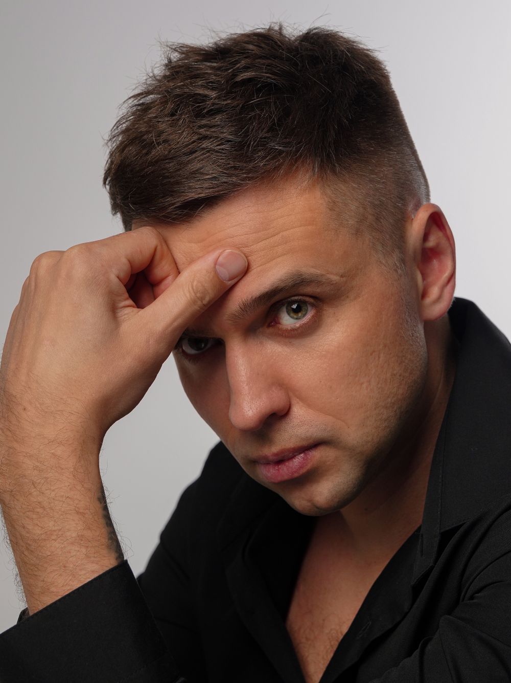 man with a short textured haircut and neat taper