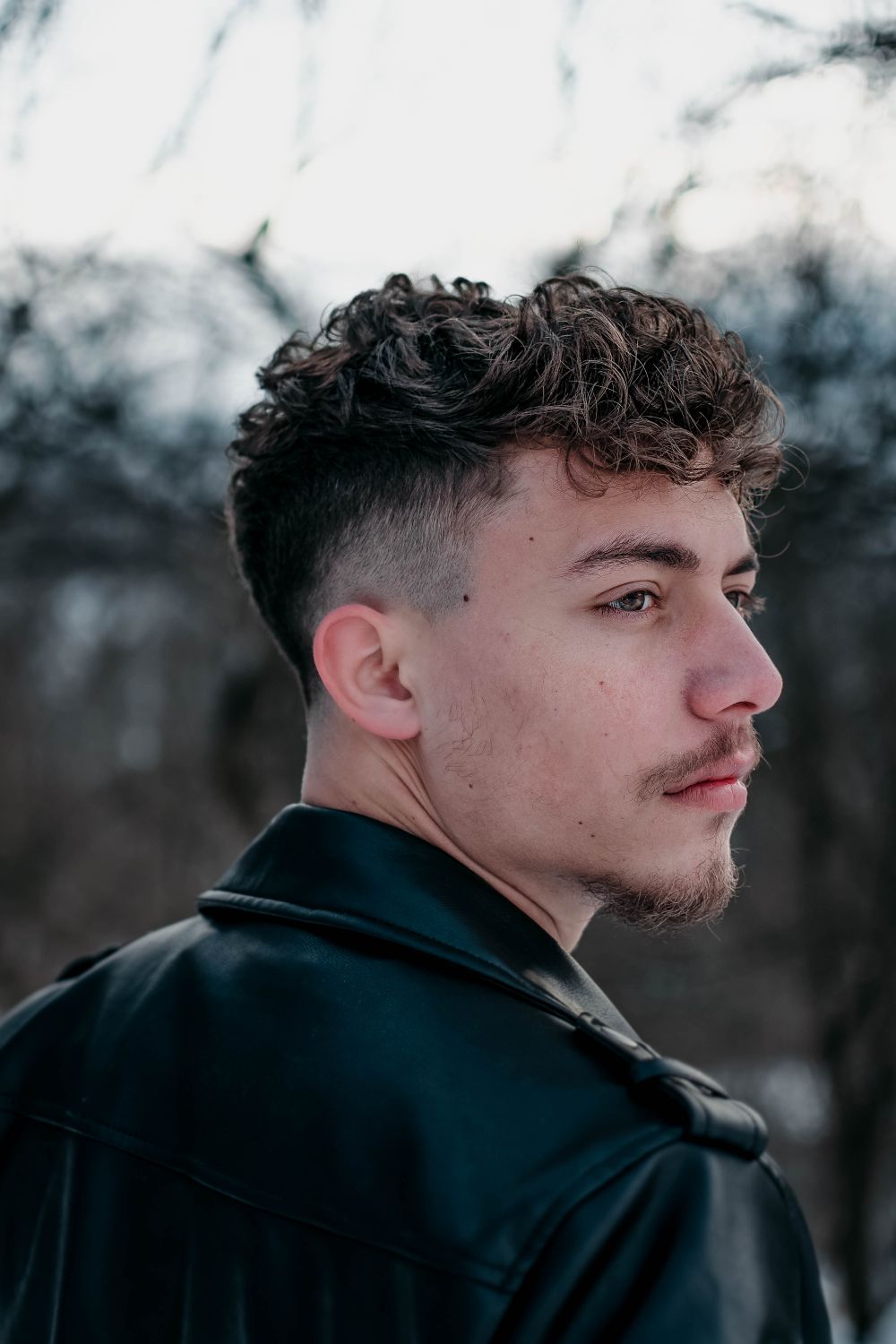 man with textured wavy top and tapered faded sides