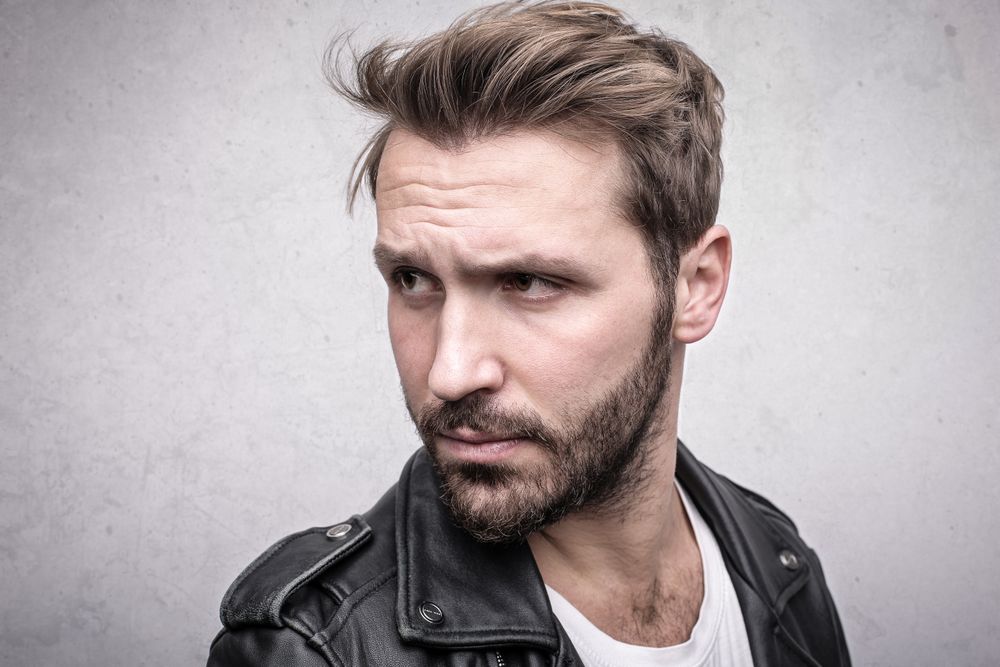 man with textured medium haircut and widow's peak
