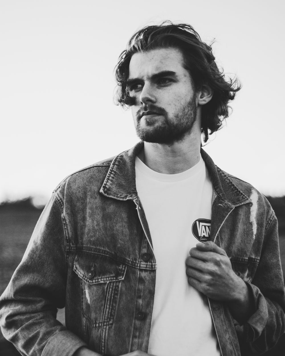 man with medium wavy hair and light taper