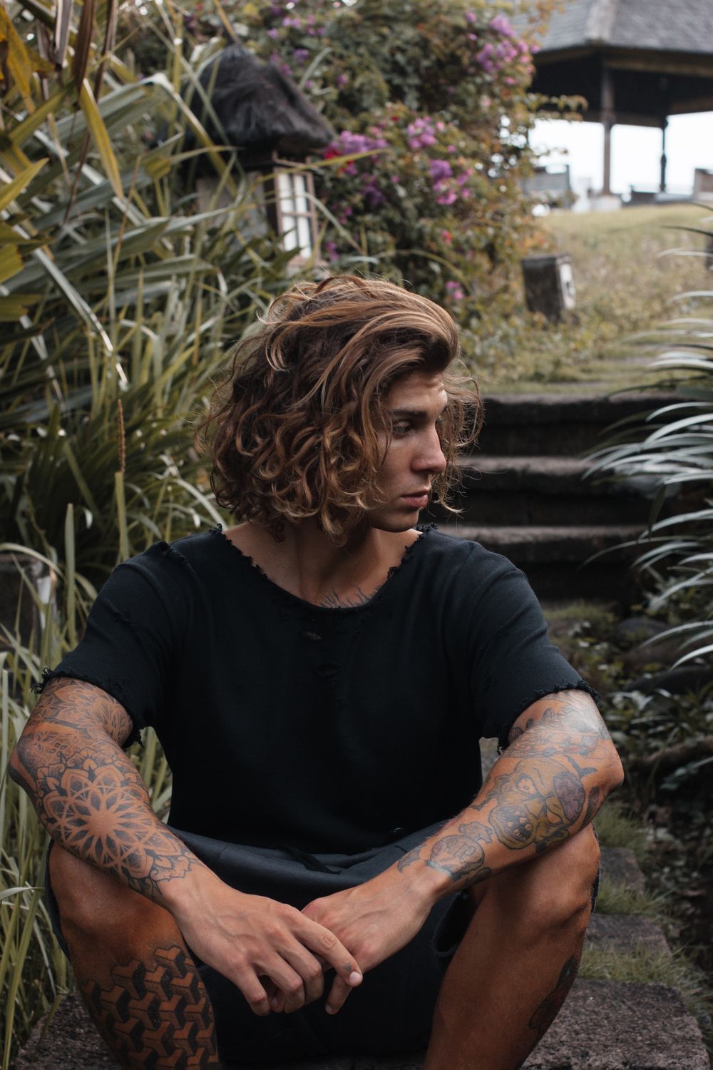 man with shoulder length wavy hair and natural texture